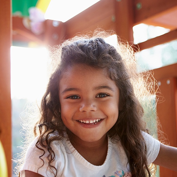 Little girl smiling and playing