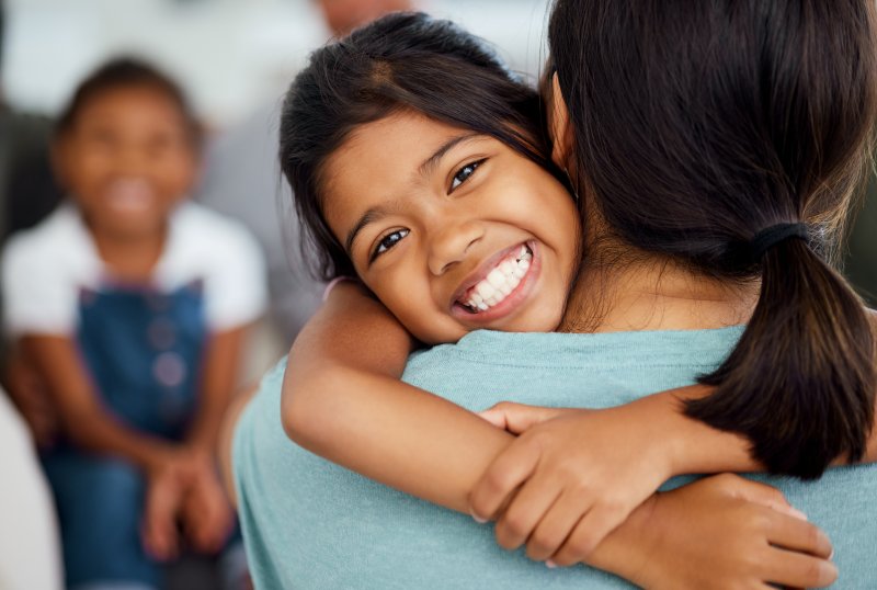 Young patient smiling after getting dental sealants