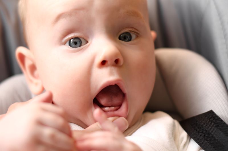 A smiling baby with teeth